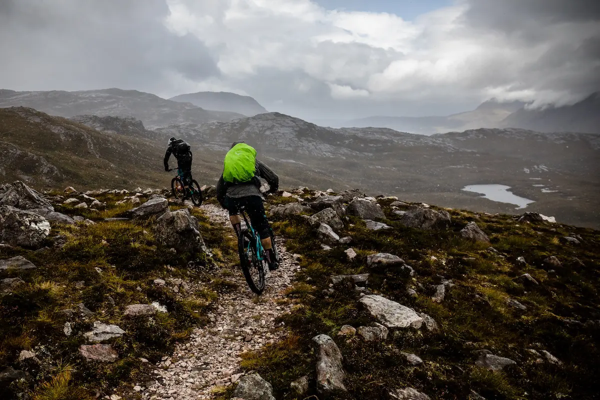 Mountain bikers riding in the rain in the Highlands of Scotland