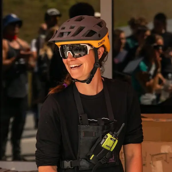 Female MTB guide Erin Greene wearing her helmet and smiling.