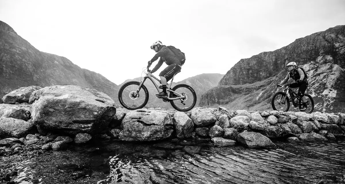 Male and female mountain bikers riding in Scotland