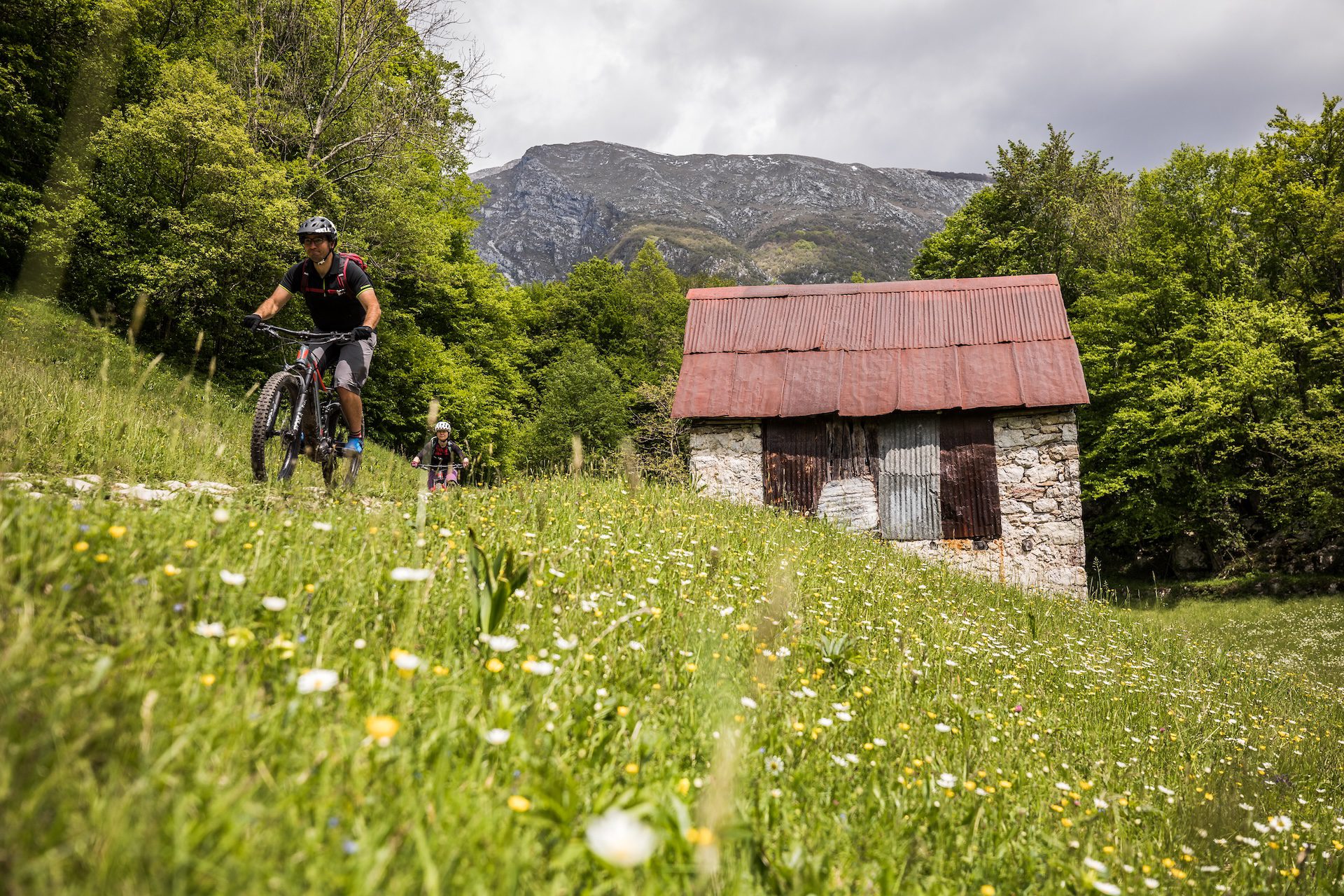 E-mountain bike guide riding through meadows in Slovenia