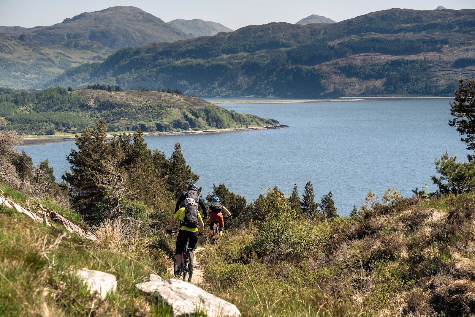 Riding a singletrack descent with views over the sea