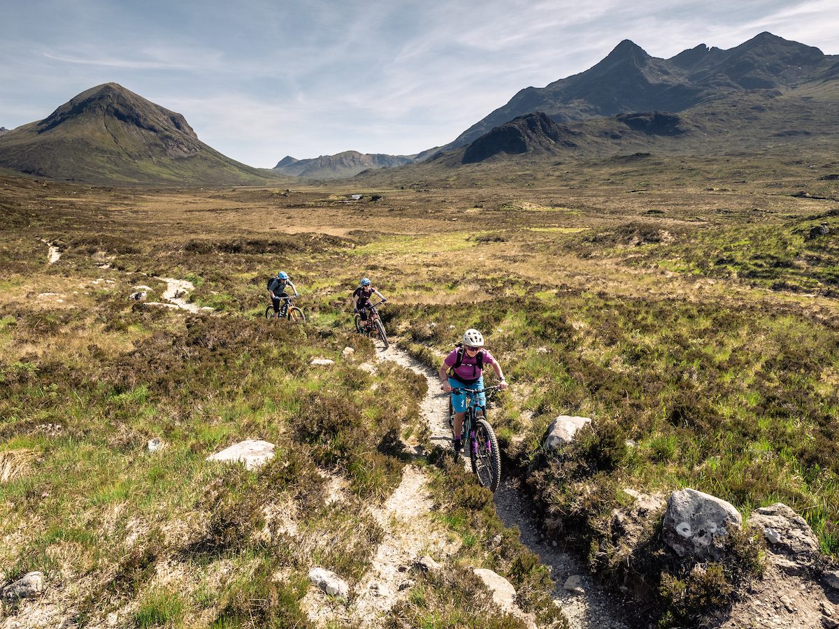 Mountain bikers, male and female, riding in Glen Sligachan on Skye
