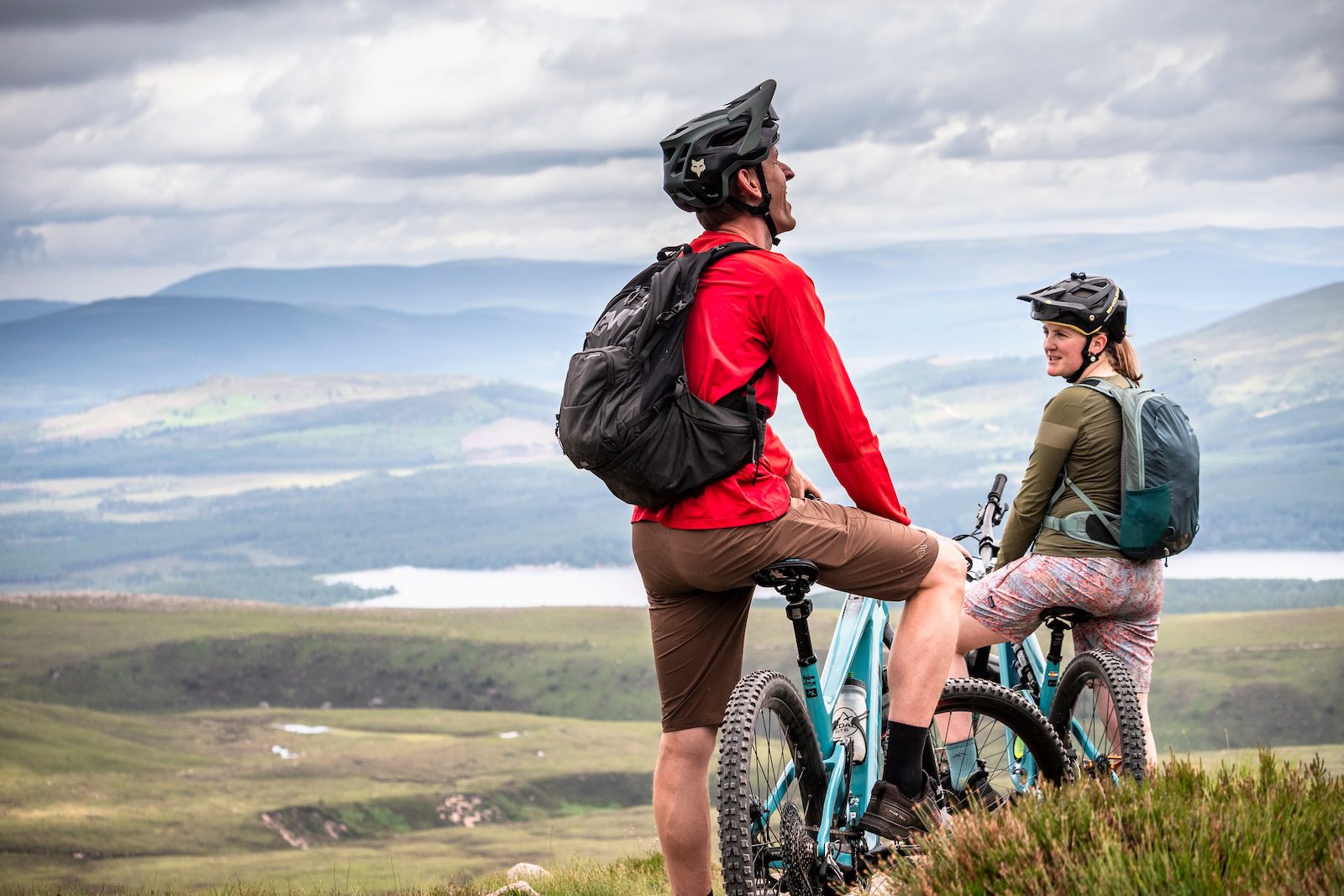 E-mountain bikers laughing and joking in the Cairngorms, Scotland