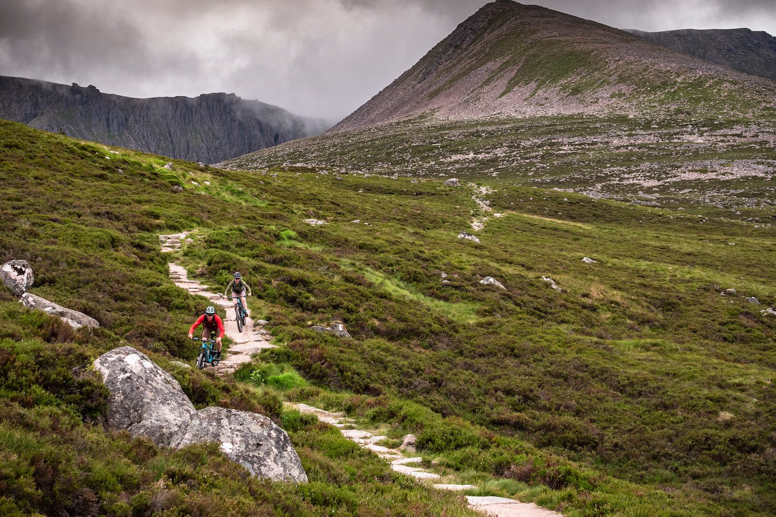 E-mountain bikers descending through the mountains of the Cairngorms