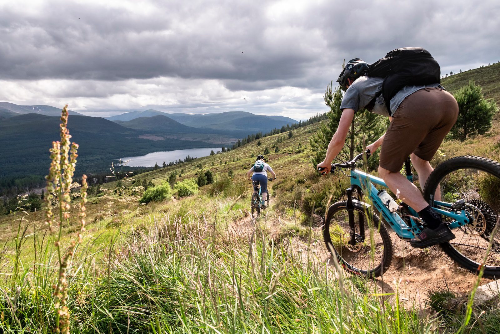 E-mountain bikers descending a dry trail in the Cairngorms Scotland