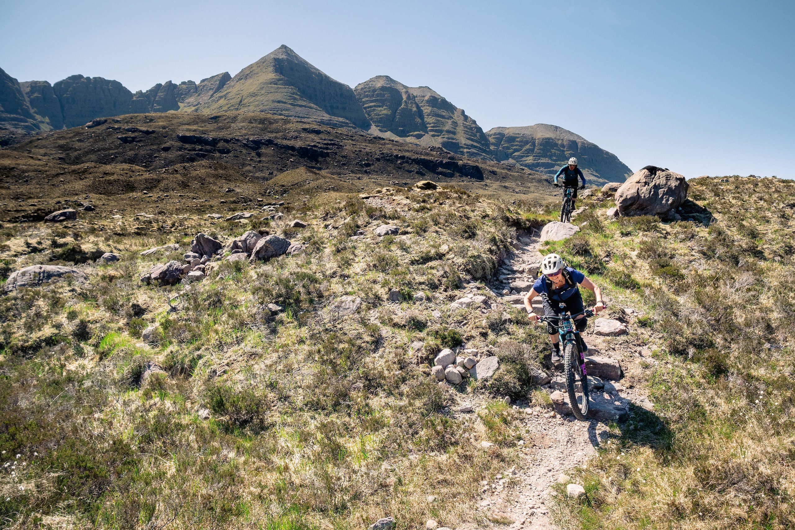 Female and male mountain bikers riding in Torridon, Scotland