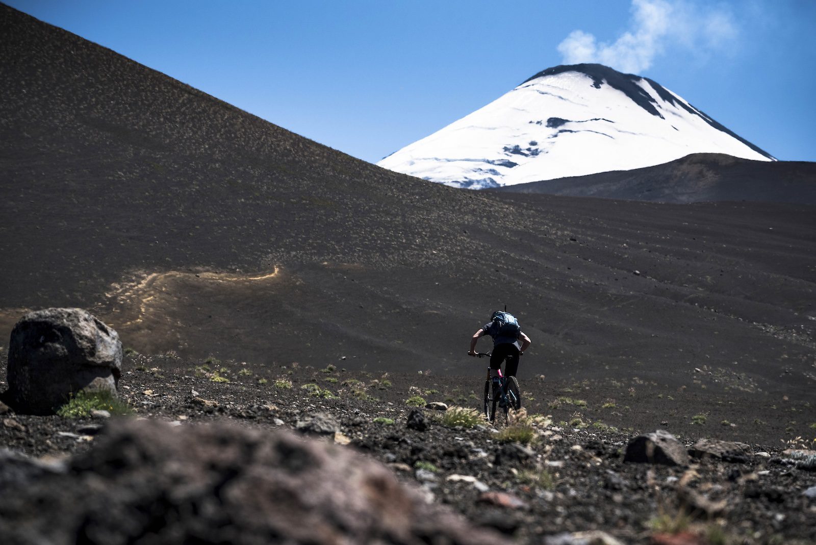 Mountain biker on a smoking volcano in Chile, complete travel guide to Chile